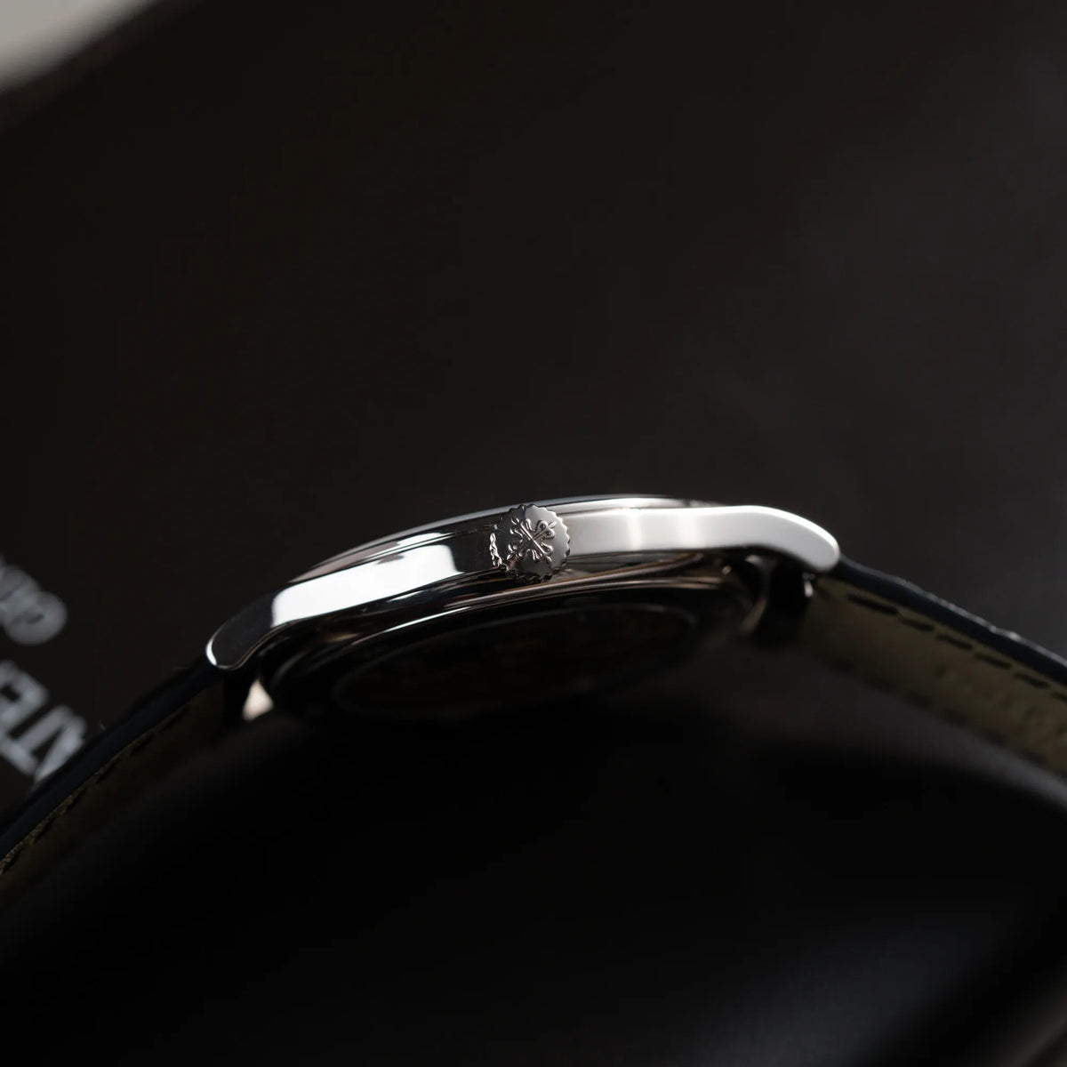 Produktfotografie der Patek Philippe Calatrava 5269G in Weißgold mit weißem Sector-Dial zeigt die seitliche Gehäuseflanke und die Aufzugskrone