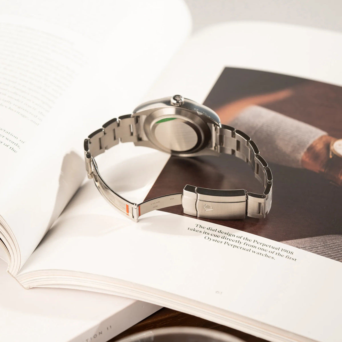 Produktfotografie der Rolex Oyster Perpetual Air King 116900 mit 40mm Gehäuse und dem klassischen schwarzen Zifferblatt mit grünem Sekundenzeiger zeigt die verklebten Sticker