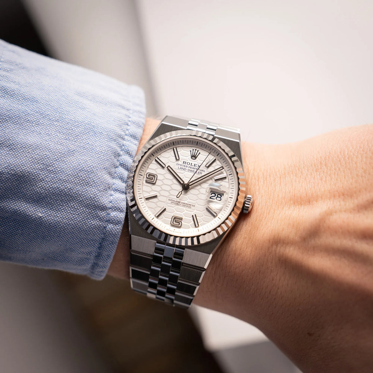 Wristshot mit der Rolex Land-Dweller 40 der Referenz 127334 im neuwertigen Zustand mit dem weißen Zifferblatt in Waben-Struktur am neuen Flat-Jubilee-Armband