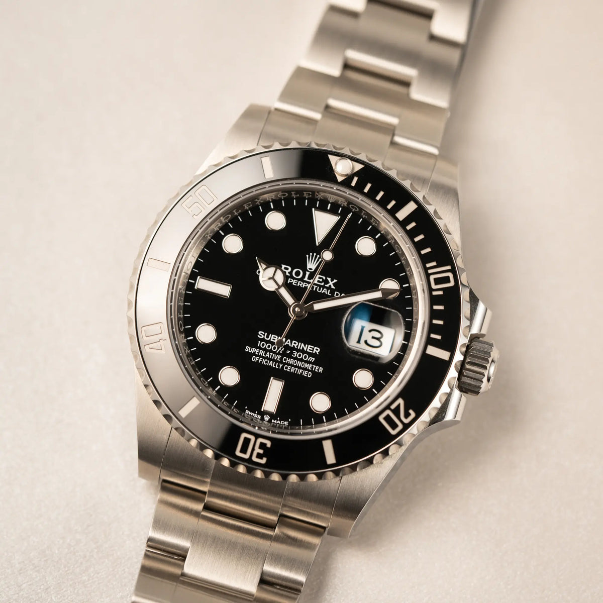Nahaufnahme des Uhrenkopfes der Rolex Submariner Date in schwarz mit Keramik-Lünette am Oyster-Stahlband aus 2023 mit dem 41mm-Oyster-Gehäuse