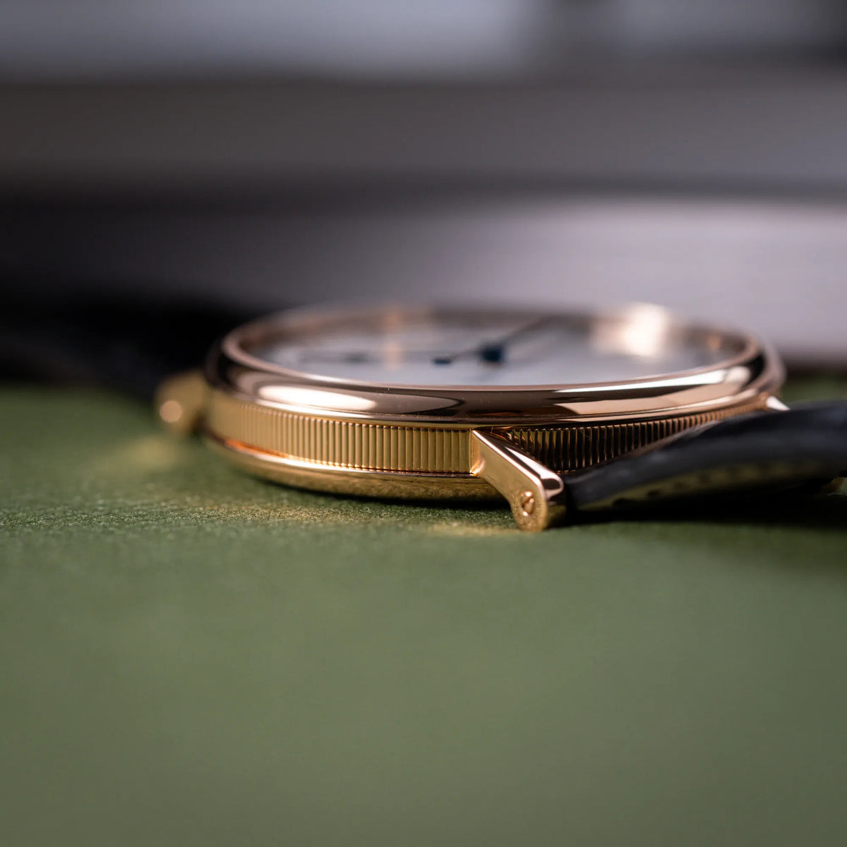 Detailaufnahme des seitlichen Uhrengehäuses der Breguet Classique 5177 in Roségold mit weißem Emaille-Zifferblatt mit kannelierter Gehäuseflanke