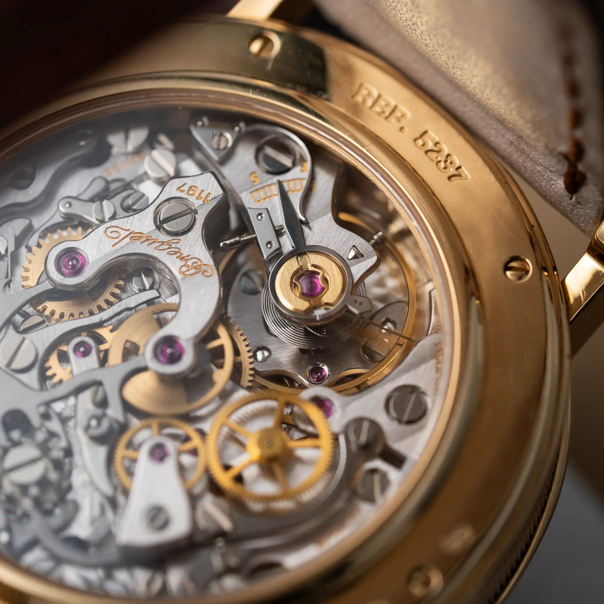 Detailaufnahme des Handaufzug-Kalibers des Breguet Classique Chronograph der Referenz 5237 in Gelbgold mit silbernem guillochiertem Zifferblatt am braunem Lederband 