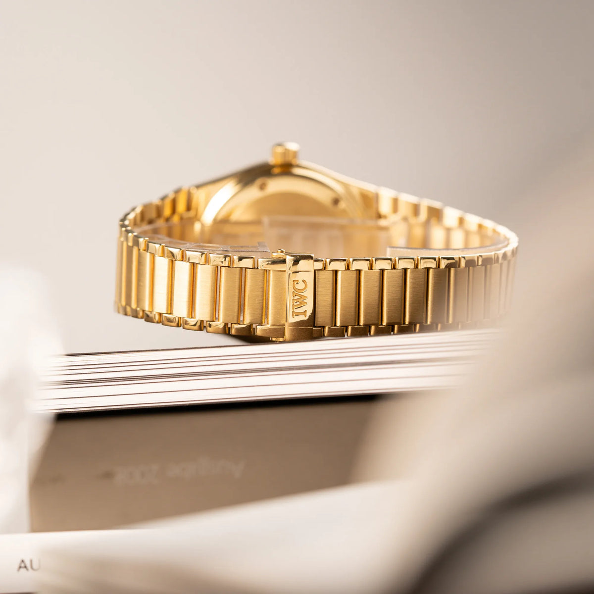 Produktfotografie der IWC Ingenieur Perpetual Calendar in Gelbgold mit weißem Zifferblatt und zughörigem Gelbgold-Armband zeigt den Zustand der  originalen IWC-Schliesse