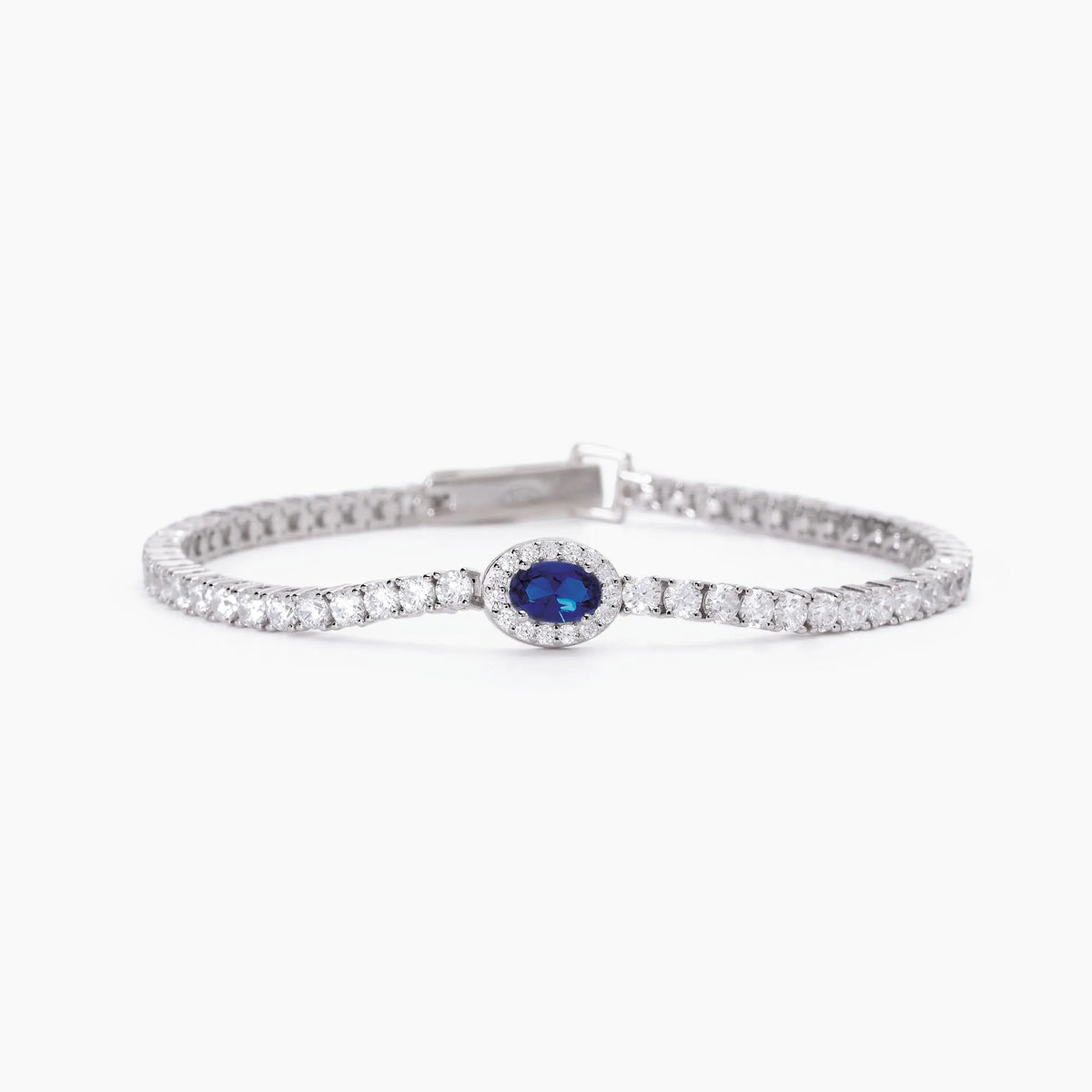 Produktfotografie des silbernen Armbands  von Mabina, ähnlich einem Tennis-Armband mit Zirkonia-Steinen, welches um ein zentrales Element mit ovalem blauem Schmuckstein ergänzt wurde