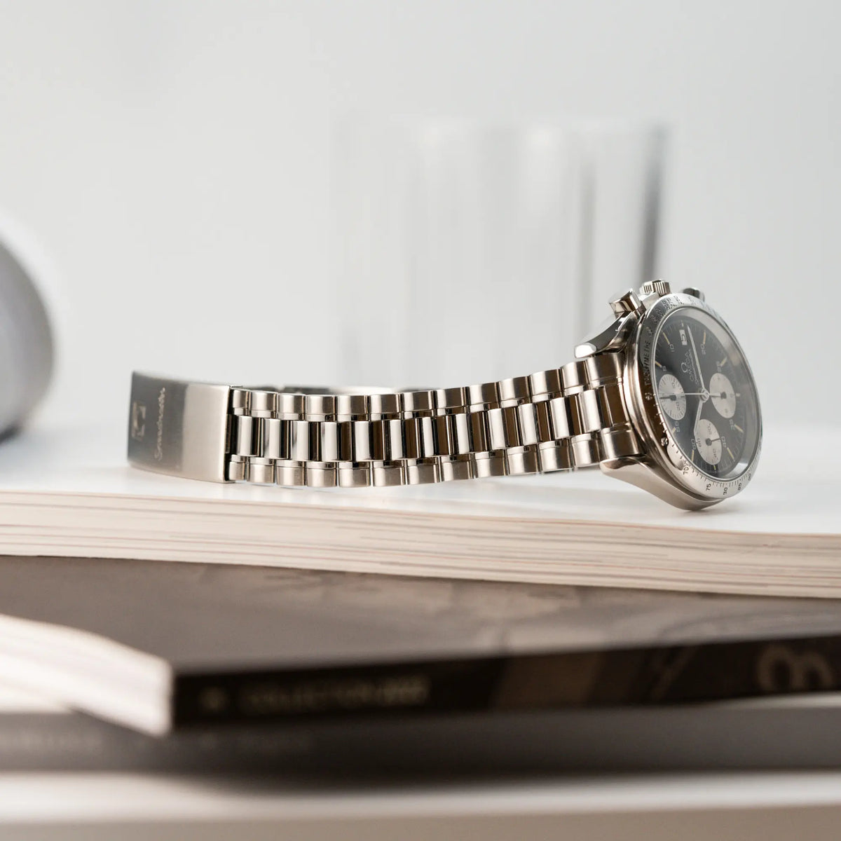 Produktfotografie der Omega Speedmaster Automatic Date mit schwarzem Zifferblatt und silbernen Totalisatoren zeigt den Zustand und Stretch des Armbandes