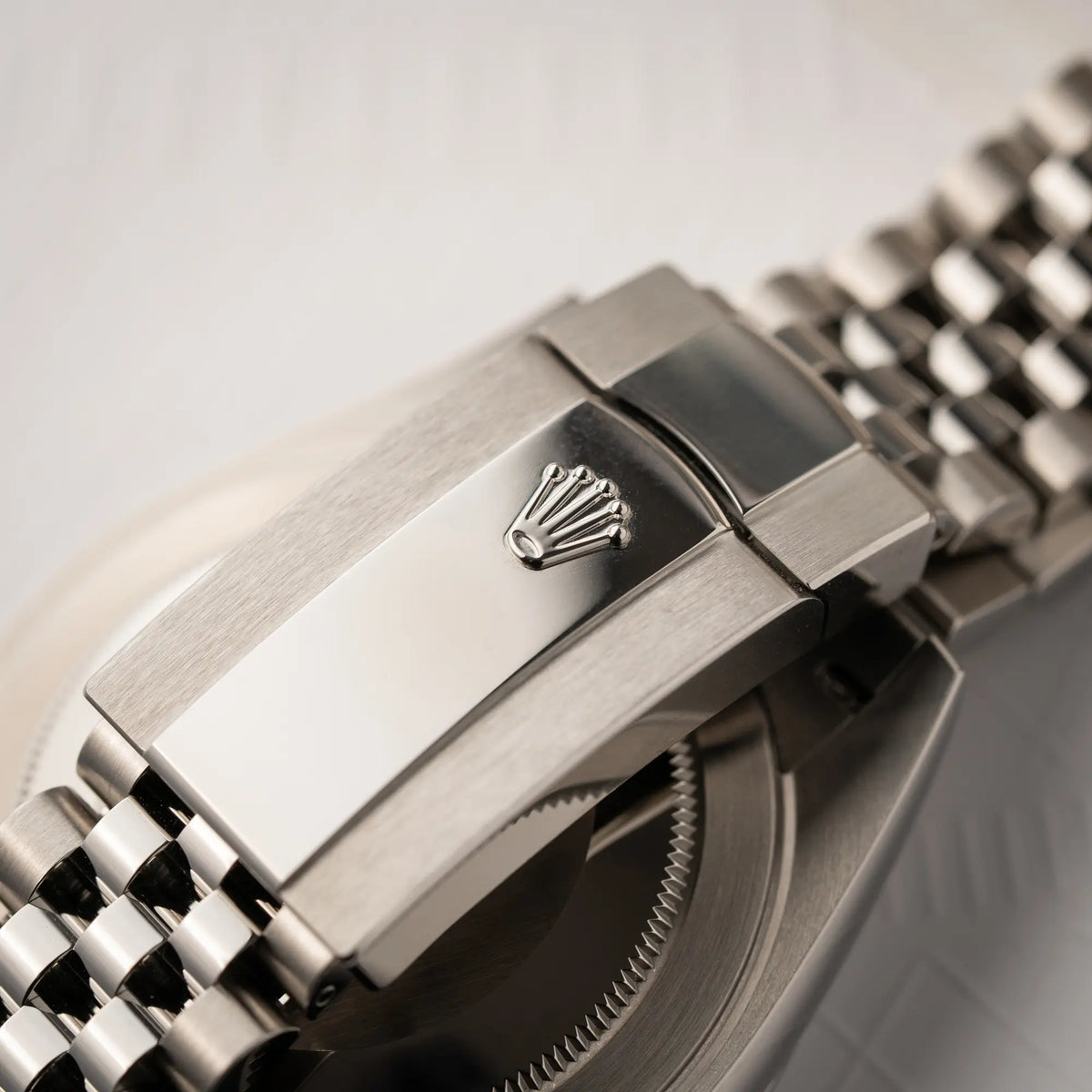 Detailaufnahme der Oyster-Schliesse mit Rolex Krone von der Rolex Datejust 41 der Referenz 126300 mit grauem Zifferblatt und glatter Lünette am Jubilee-Stahl-Armband