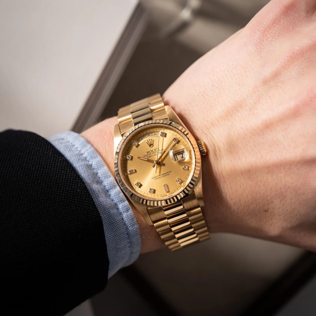 Mann trägt die Rolex Day-Date 36 aus 1991 der Referenz 18238 mit goldfarbenem Zifferblatt und Diamant Indizes in einem hervorragenden Gesamtzustand an seinem Handgelenk