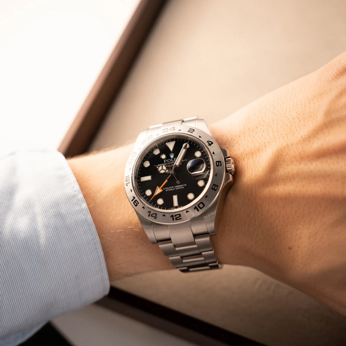 Mann trägt die Rolex Explorer 2 Orangehand im Top-Zustand der Referenz 216570 mit schwarzem Zifferblatt  an seinem Handgelenk für einen Wrisstshot