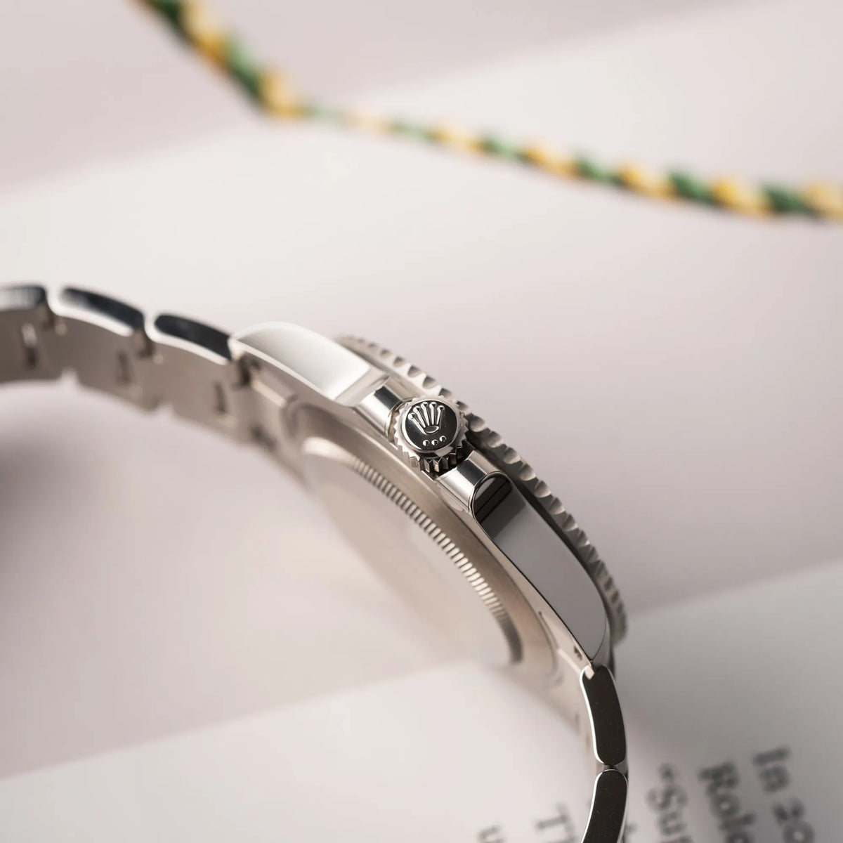 Seitliche Gehäuseflanke mit Blick auf die Aufzugskrone der Rolex Submariner Date 126610LN am Oyster-Stahlband im Neuzustand aus 2024