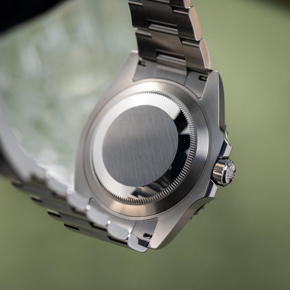 Produktfotografie zeigt den verschrauben Gehäuseboden aus Edelstahl von der Rolex Submariner No Date der Referenz 124060 im 41mm-Oyster-Case mit schwarzem Zifferblatt und schwarzem Keramik-Lünetten-Inlay