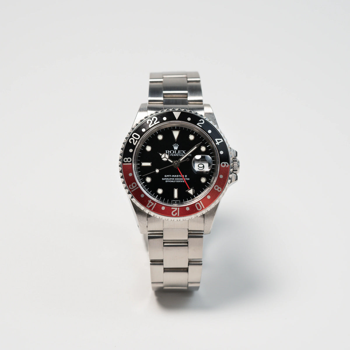 Frontale Ansicht der Rolex GMT Master 2 (Referenz 16710) mit der Coke-Lünette in schwarz-rot mit dem "Swiss-Only" Zifferblatt
